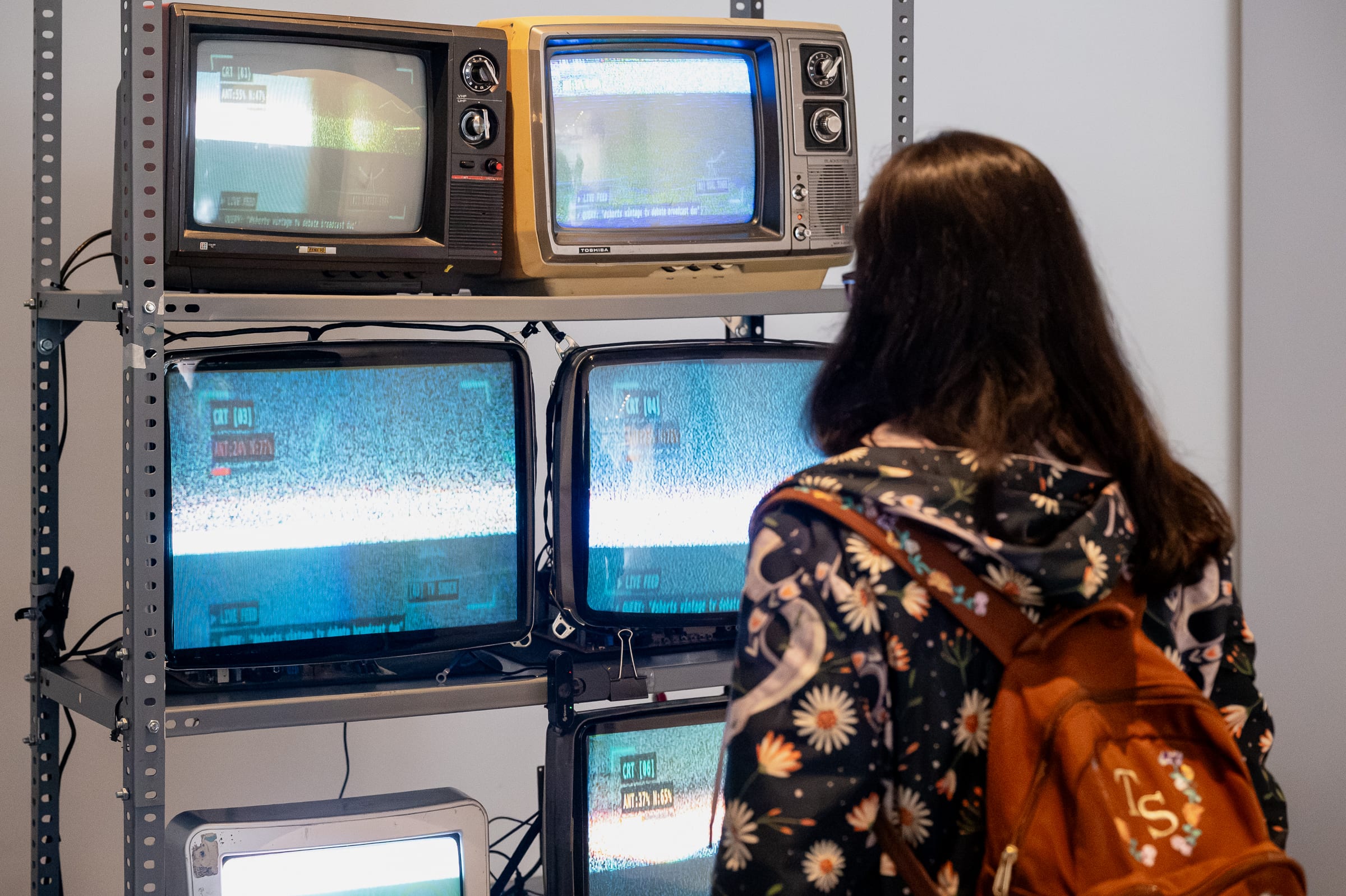 Close-up of the CRT screens displaying per-screen calibration HUD overlays, antenna lock percentages, and the CRT [01} label typo